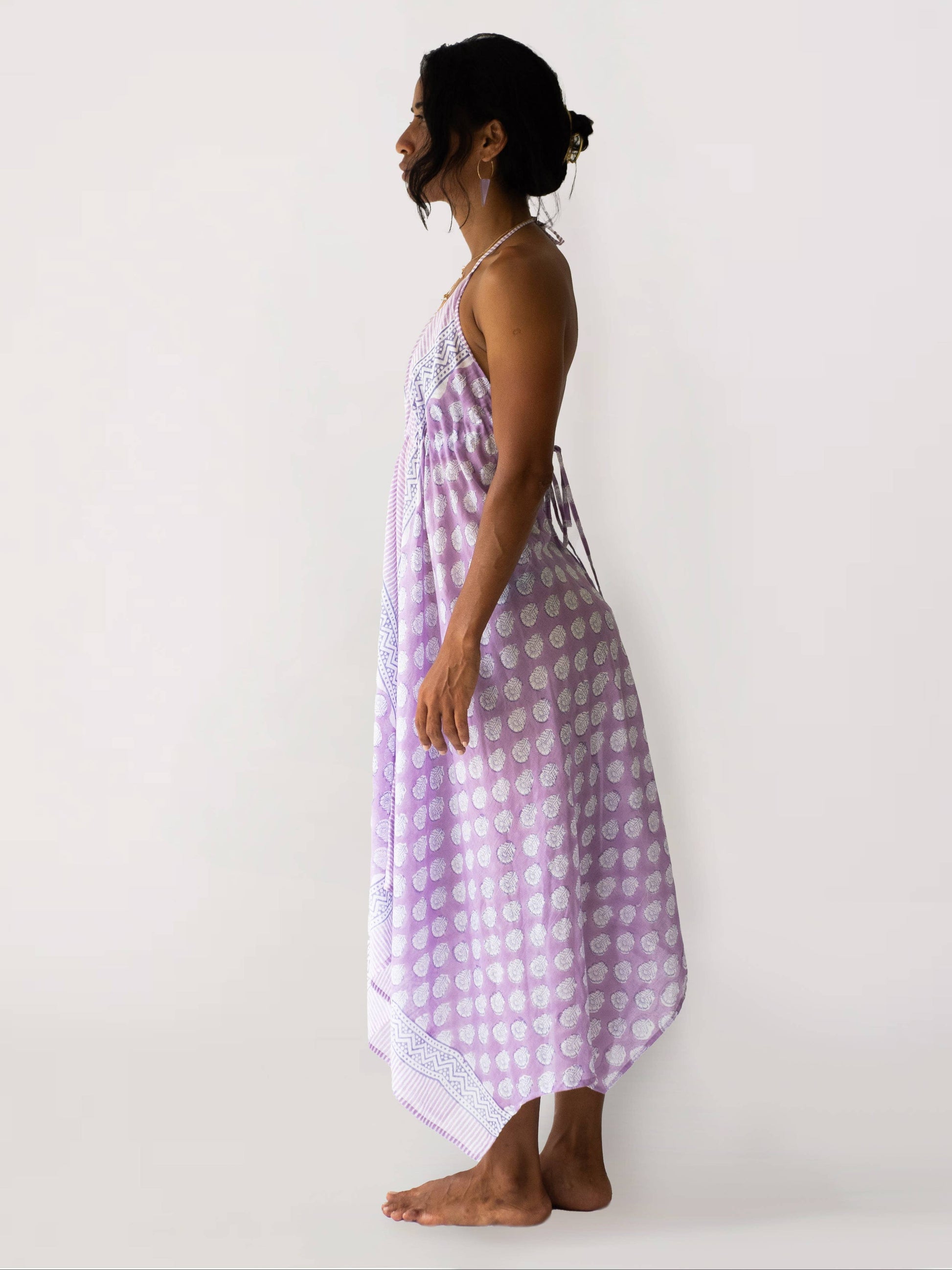 Woman wearing a purple checkered dress against a white background