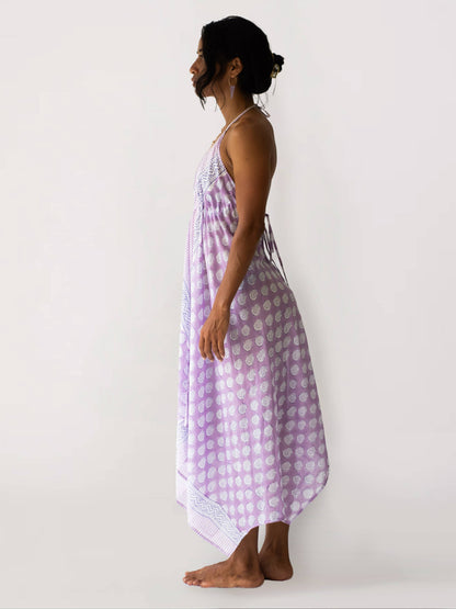 Woman wearing a purple checkered dress against a white background