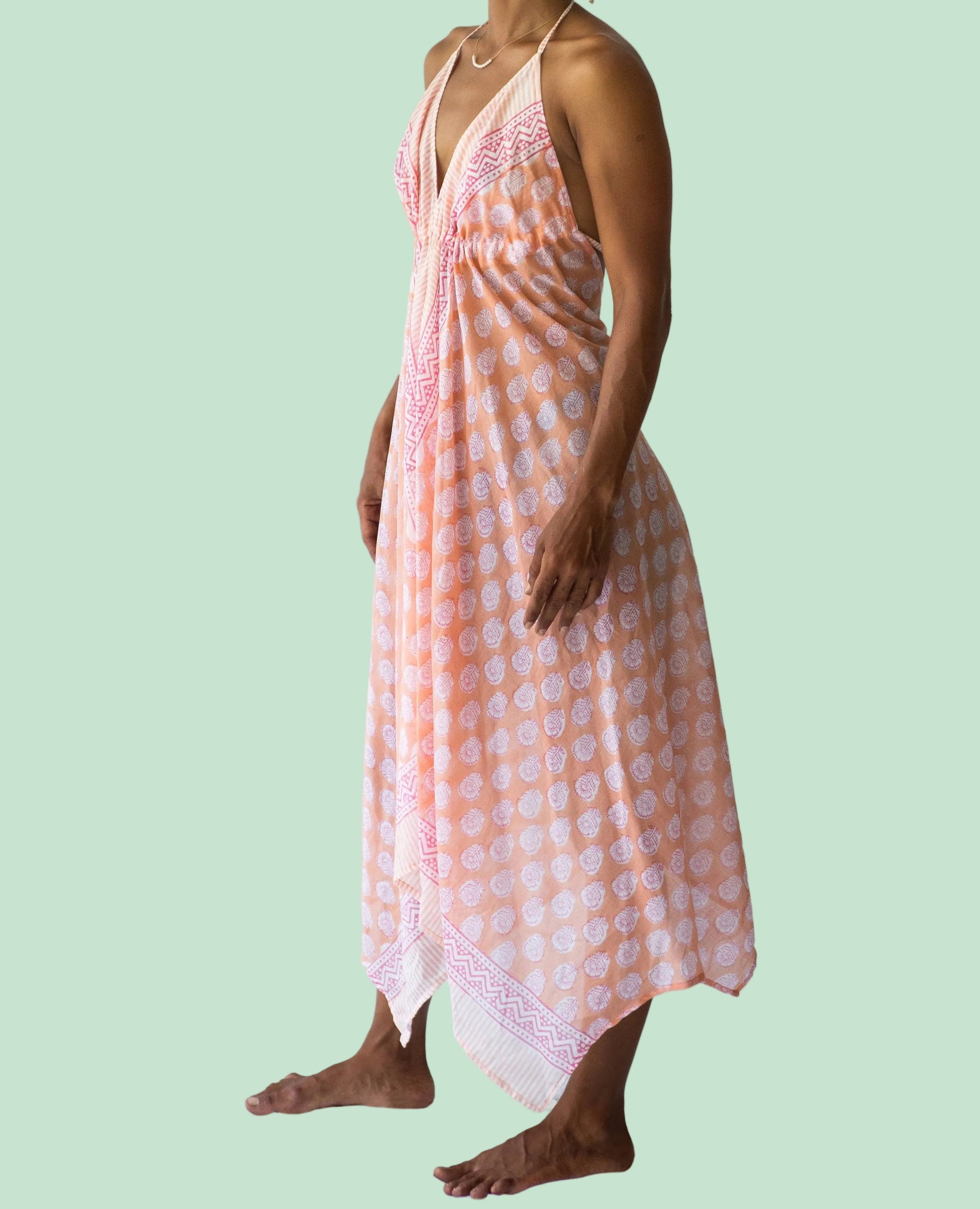 Woman wearing a pink and white checkered dress on a white background