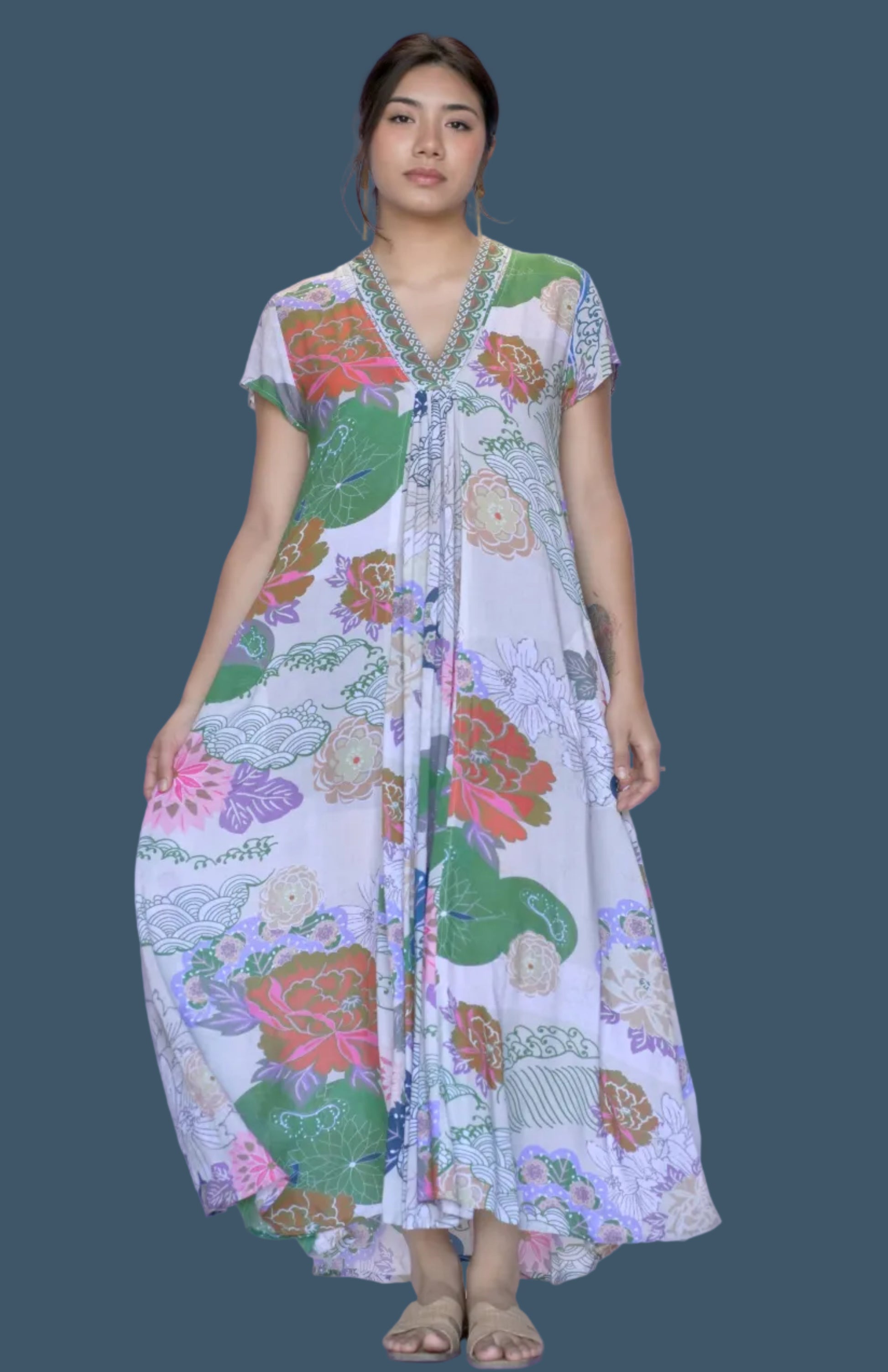 Woman wearing a colorful floral dress on a white background