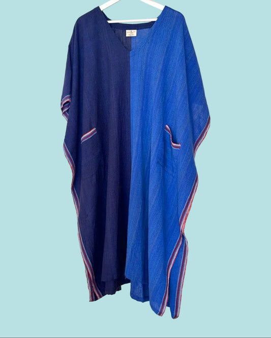 Blue dress with pink accents on a hanger against a gray background