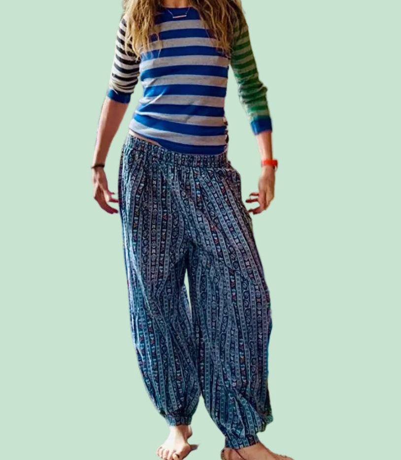 Petra wearing a striped shirt and balloon pants .