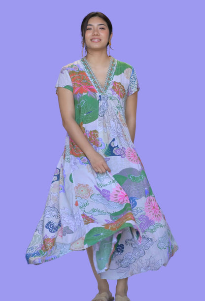 Woman wearing a colorful patterned dress on a white background